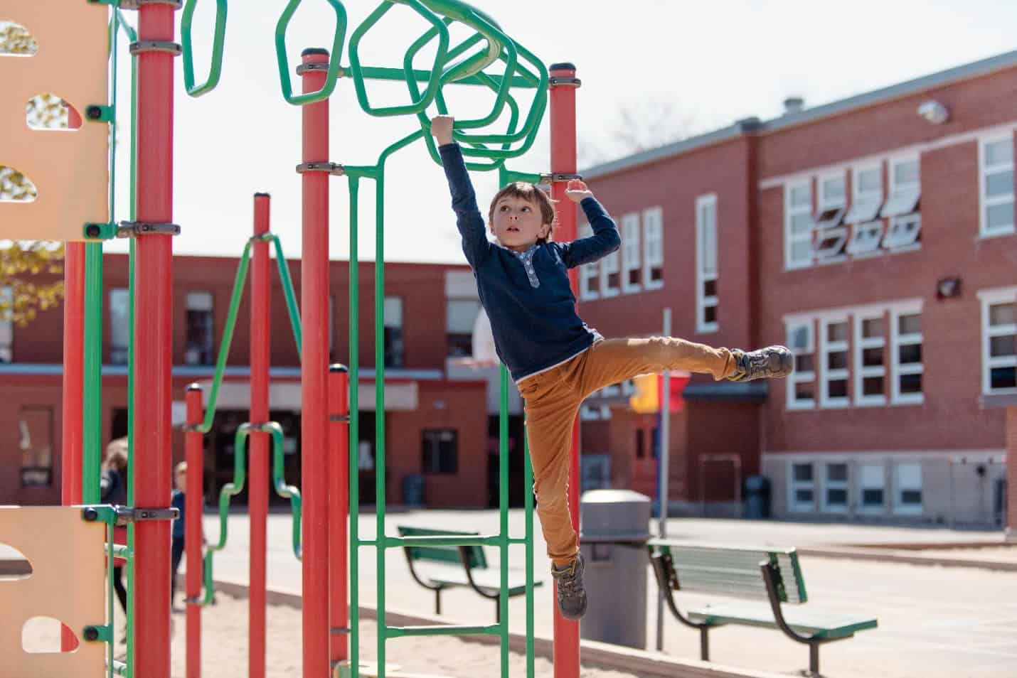 child playing on climbing structure