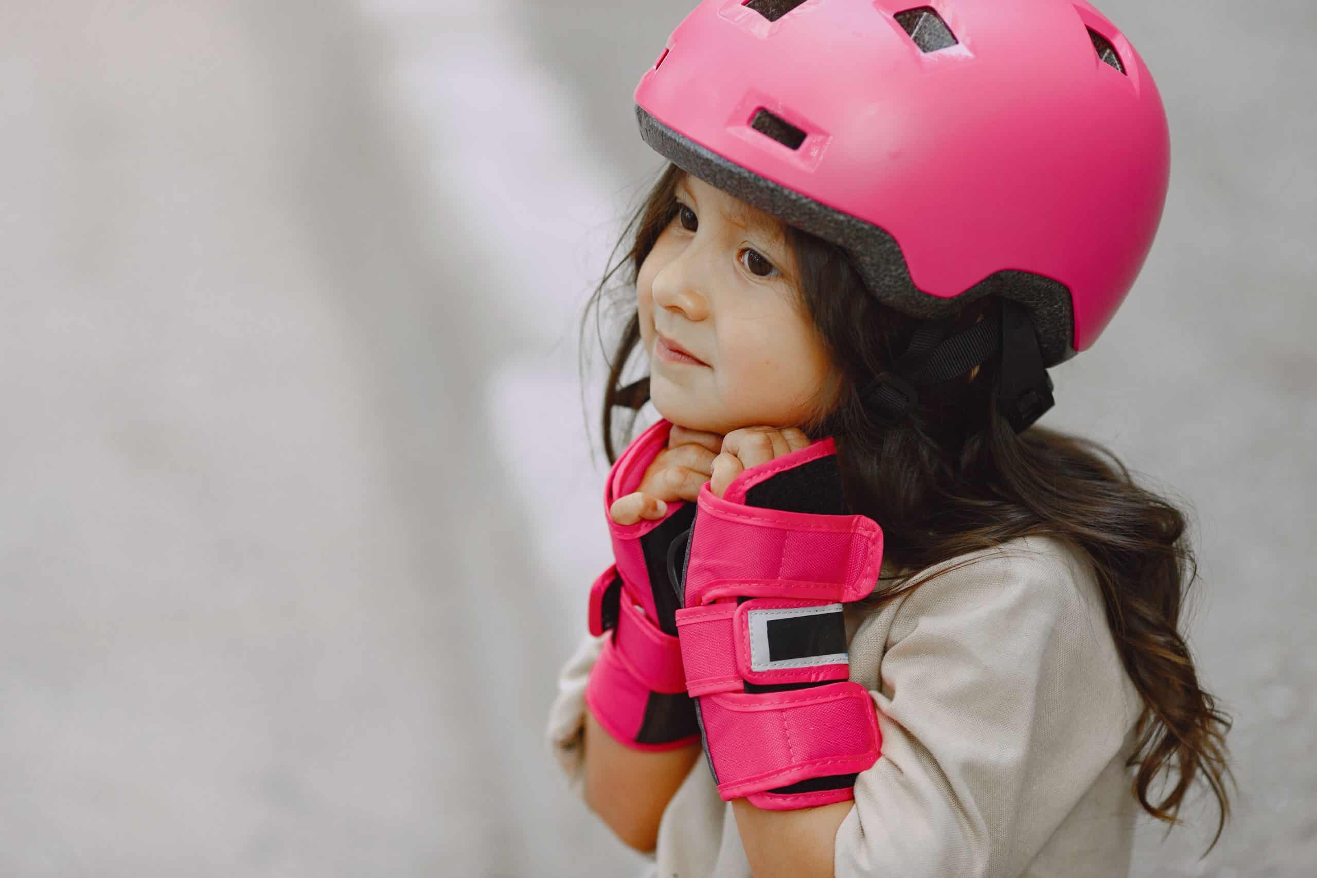 Child in yellow rain jacket riding a tricycle